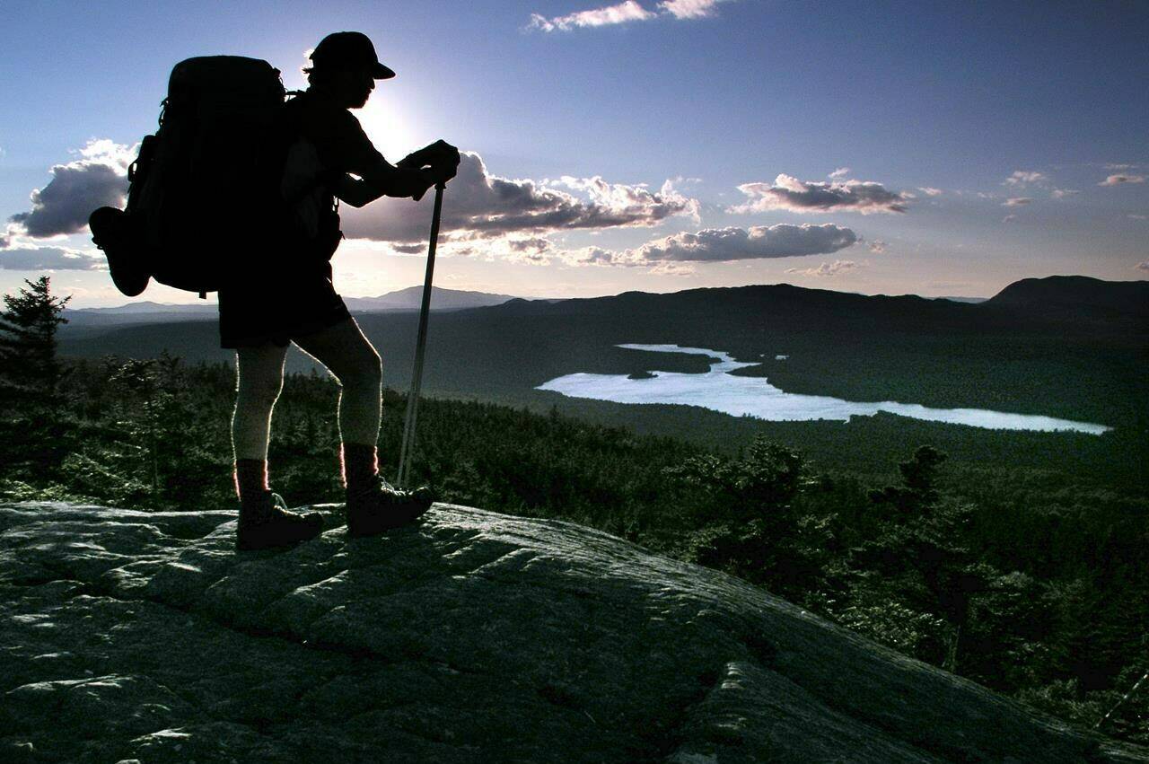 A hiker pauses on Chairback Mountain overlooking Long Pond on the 100-Mile Wilderness section of the Appalachian Trail north of Monson, Maine, in this September 2004 file photo. (THE CANADIAN PRESS/AP/Robert F. Bukaty)