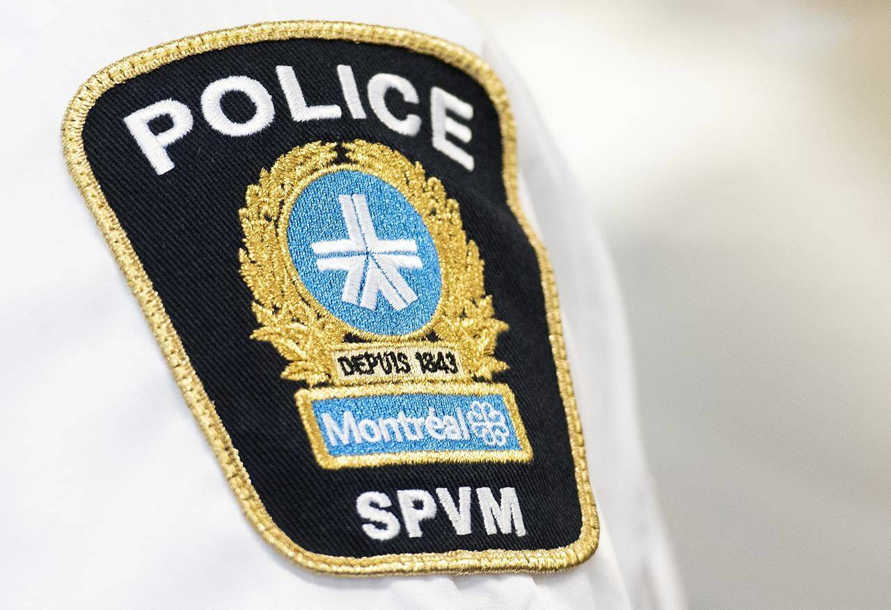 A Black Montreal man is suing Montreal police and two officers after being handcuffed and arbitrarily detained after officers suspected he had stolen his own car. A Montreal police badge is shown during a news conference in Montreal, Thursday, August 4, 2022.THE CANADIAN PRESS/Graham Hughes