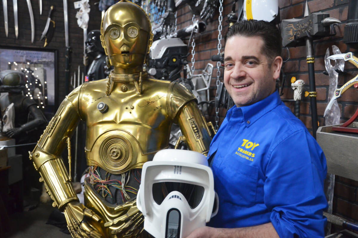 Toy Traders owner Matthew Purdy with a C-3P0 statue signed by actor Anthony Daniels. May 4 is an unofficial holiday for Star Wars fans. (Matthew Claxton/Langley Advance Times)