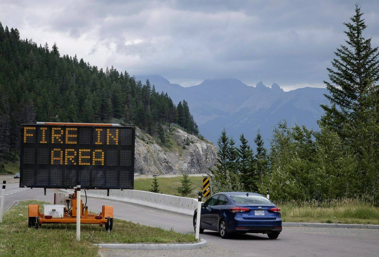 An out of control wildfire has caused thousands of people to flee their homes in Drayton Valley, Alta., a town about 140 kilometres west of Edmonton. A sign warns of a forest fire in Banff National Park, Friday, July 21, 2017. THE CANADIAN PRESS/Jeff McIntosh