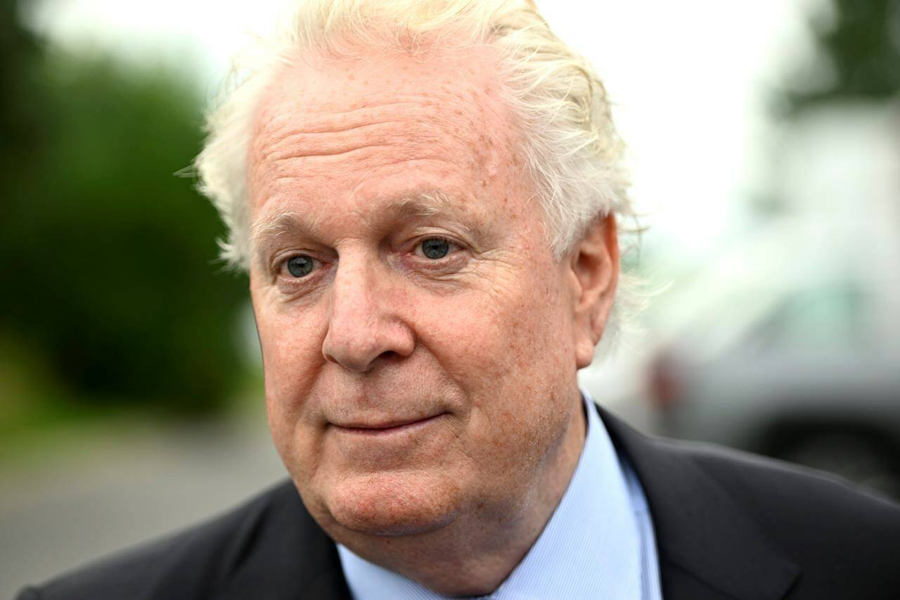 Former Quebec premier Jean Charest is demanding another $700,000 from the provincial government for media leaks related to a corruption investigation targeting him and his former Liberal party. Charest speaks to reporters in Ottawa, on Wednesday, Aug. 3, 2022. THE CANADIAN PRESS/Justin Tang