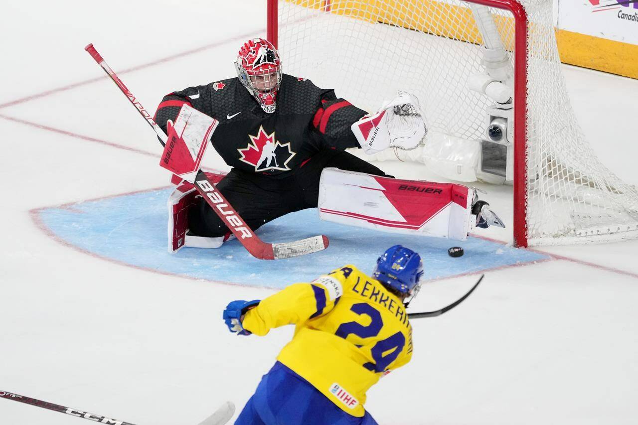 Canada’s goaltender Thomas Milic, left, stretches to make a pad save on Sweden’s Jonathan Lekkerimaki during second period IIHF World Junior Hockey Championship action in Halifax, Saturday, Dec. 31, 2022. The Vancouver Canucks’ top draft pick from 2022 says he’s looking to develop and put last season’s illness and injury struggles behind him. THE CANADIAN PRESS/Darren Calabrese