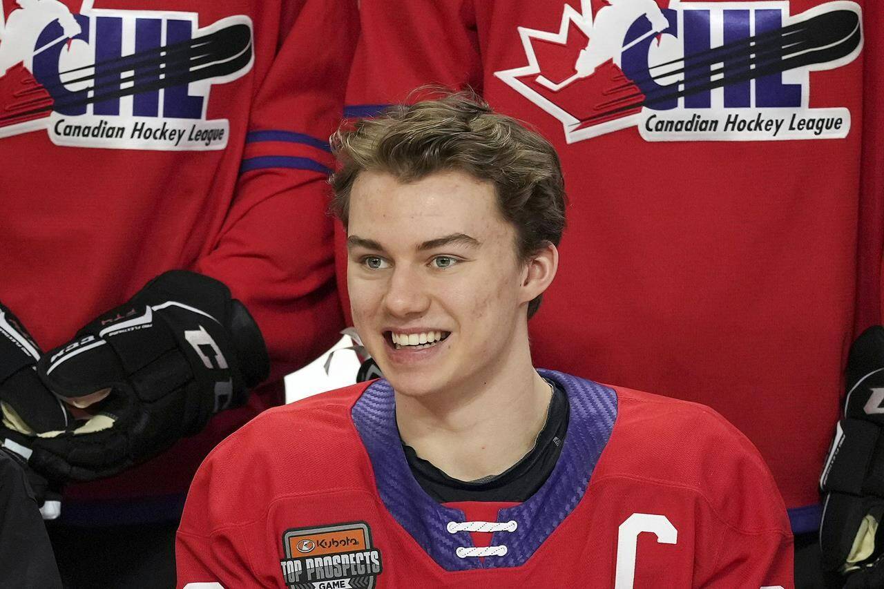 FILE - Regina Pats’ Connor Bedard smiles for a team photo ahead of the CHL/NHL Top Prospects game, in Langley, British Columbia, Wednesday, Jan. 25, 2023. The NHL draft lottery is drawn, determining which team gets the chance to select Connor Bedard with the No. 1 pick. The Anaheim Ducks, Columbus Blue Jackets and Chicago Blackhawks have the highest odds of landing the most anticipated top pick since Connor McDavid in 2015. (Darryl Dyck/The Canadian Press via AP, File)