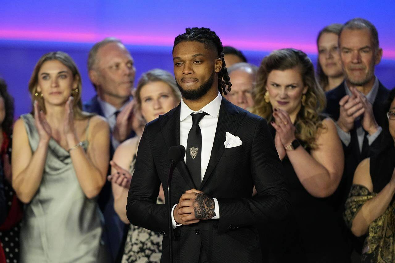 FILE - Buffalo Bills’ Damar Hamlin speaks in front of University of Cincinnati Medical Center staff during the NFL Honors award show ahead of the Super Bowl 57 football game, Thursday, Feb. 9, 2023, in Phoenix. Damar Hamlin will put the $9.1 million given to a GoFundMe campaign by well-wishers after his on-field collapse into his own nonprofit, the Chasing M’s Foundation. The decision, first shared with The Associated Press Monday, May 8, 2023, is a first step in the 25-year-old’s plan for the unprecedented outpouring of support that he received after his heart stopped following a tackle during a Monday night football game in January. (AP Photo/David J. Phillip, File)