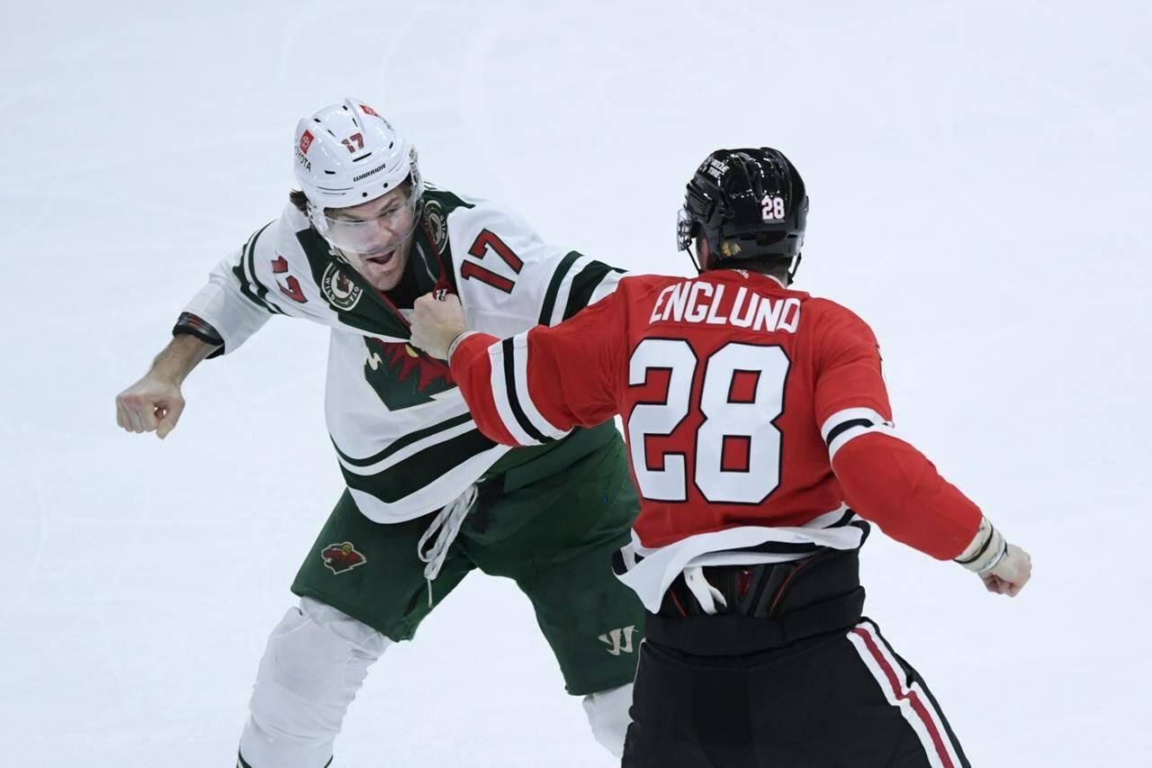 Minnesota Wild’s Marcus Foligno (17) fights Chicago Blackhawks’ Andreas Englund (28) during the third period of an NHL hockey game Monday, April 10, 2023, in Chicago. A study looking at National Hockey League players who spend more time dropping the gloves or in the penalty box tend to live 10 years less than their peers. THE CANADIAN PRESS/AP/Paul Beaty