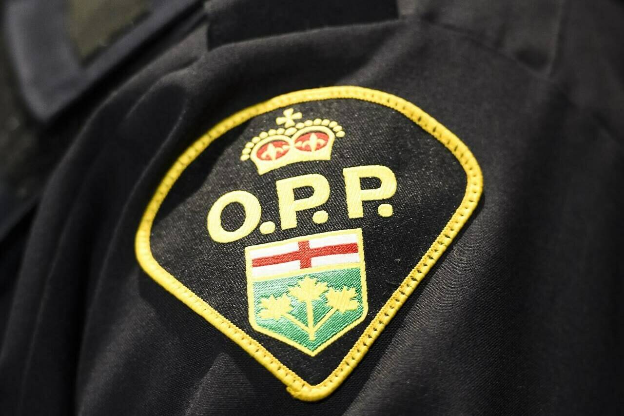 An Ontario Provincial Police logo is shown in Barrie, Ont., on Wednesday, April 3, 2019. Ontario Provincial Police say one officer is dead and two others were injured in an early morning shooting in a village east of Ottawa. THE CANADIAN PRESS/Nathan Denette