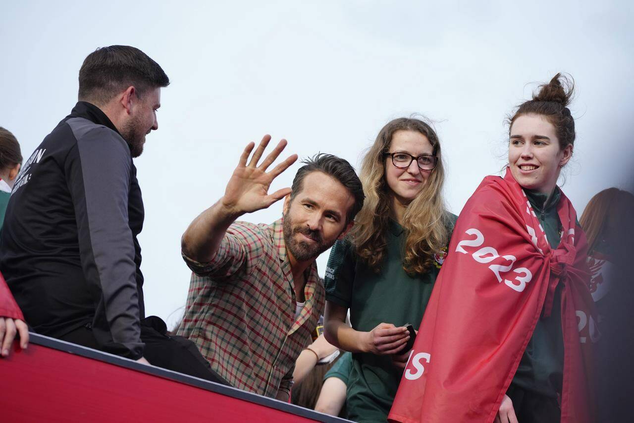 Wrexham co-owner Ryan Reynolds, center, celebrates with members of the Wrexham FC soccer team the promotion to the Football League in Wrexham, Wales, Tuesday, May 2, 2023. THE CANADIAN PRESS/AP-Jon Super
