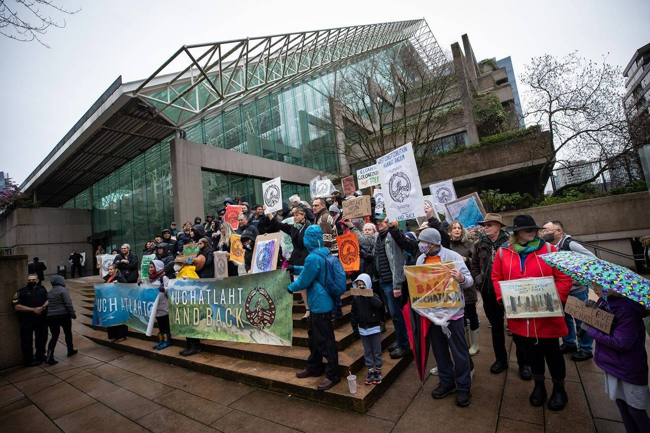 Members of the Nuchatlaht First Nation and supporters rally outside B.C. Supreme Court before the start of an Indigenous land title case, in Vancouver, on Monday, March 21, 2022. A British Columbia Supreme Court judge says the First Nation did not prove it had rights to its entire claim area, although he suggested it may be time for the provincial government to rethink its current test for such titles. THE CANADIAN PRESS/Darryl Dyck
