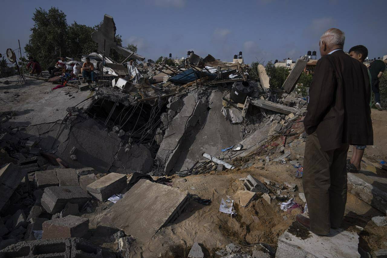 Palestinians inspect the rubble of a house after it was struck by an Israeli airstrike in Beit Lahia, northern Gaza Strip, Friday, May 12, 2023. On the fourth day of fighting between Israel and Islamic Jihad, the second-largest militant group in Gaza.(AP Photo/Fatima Shbair)