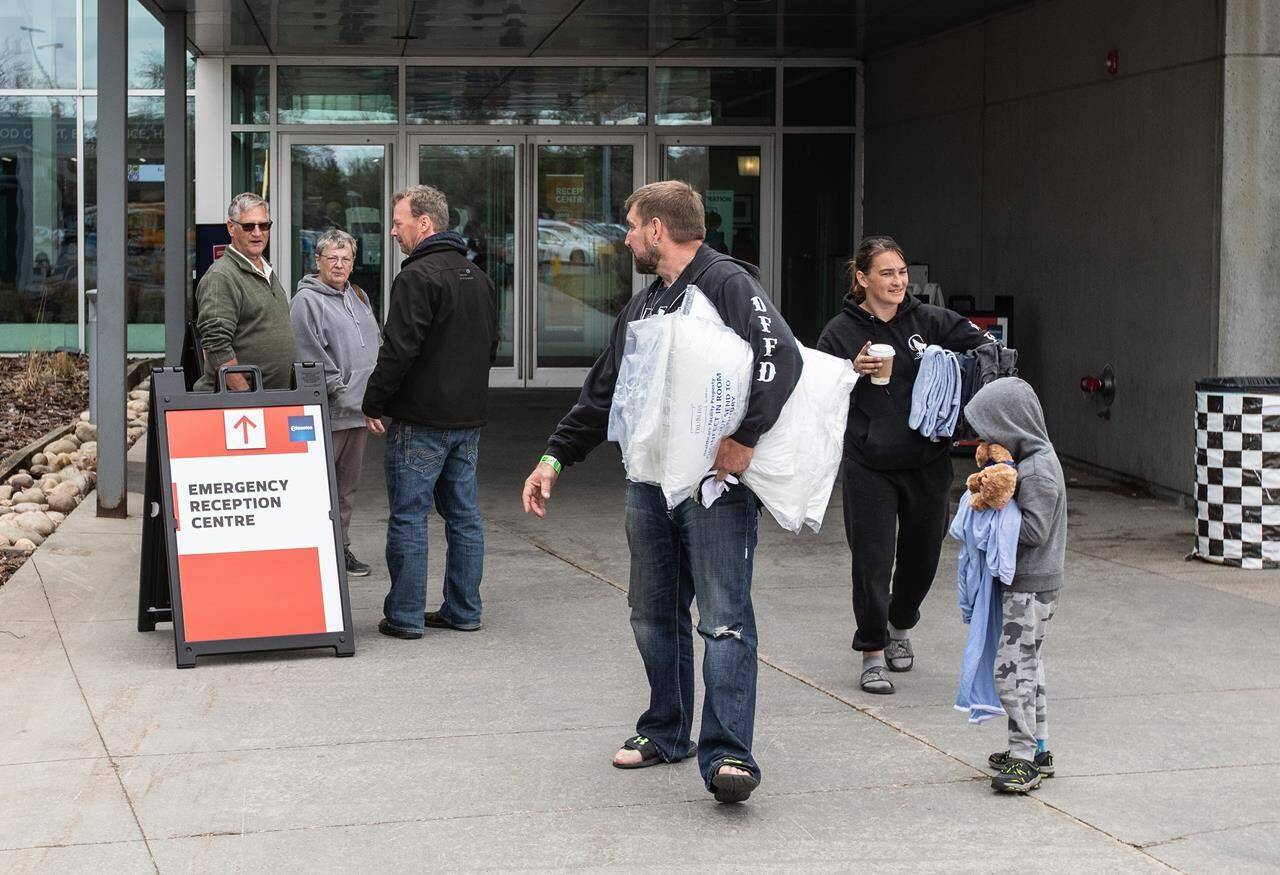 Wildfire evacuees get supplies and get checked in at the evacuation centre in Edmonton, Sunday, May 7, 2023. Many Albertans are pitching in to help the thousands of people who have been displaced by wildfires in recent weeks. THE CANADIAN PRESS/Jason Franson.