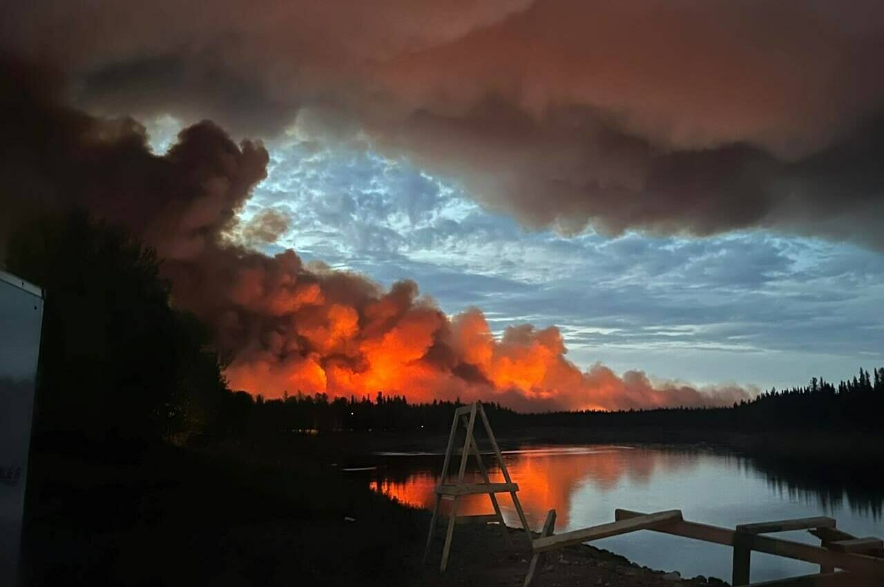 Fire and smoke from a wildfire are shown in Hay River, Northwest Territories. A First Nation reserve and nearby town in the southern Northwest Territories have been evacuated as a wildfire spreads in the area. THE CANADIAN PRESS/James Cardinal Jr.