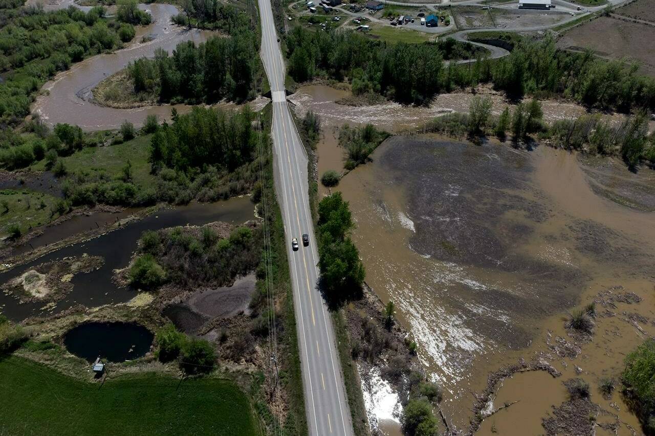 Overland flooding is seen as the swollen Bonaparte River runs through the Bonaparte First Nation while motorists travel on the Cariboo Highway, north of Cache Creek, B.C., on Sunday, May 14, 2023. Special weather statements covered much of British Columbia’s coastal and interior regions with temperatures soaring above 30 degrees in many communities on the weekend, but meteorologist Louis Kohanyi says they’re expected to peak today.	THE CANADIAN PRESS/Darryl Dyck