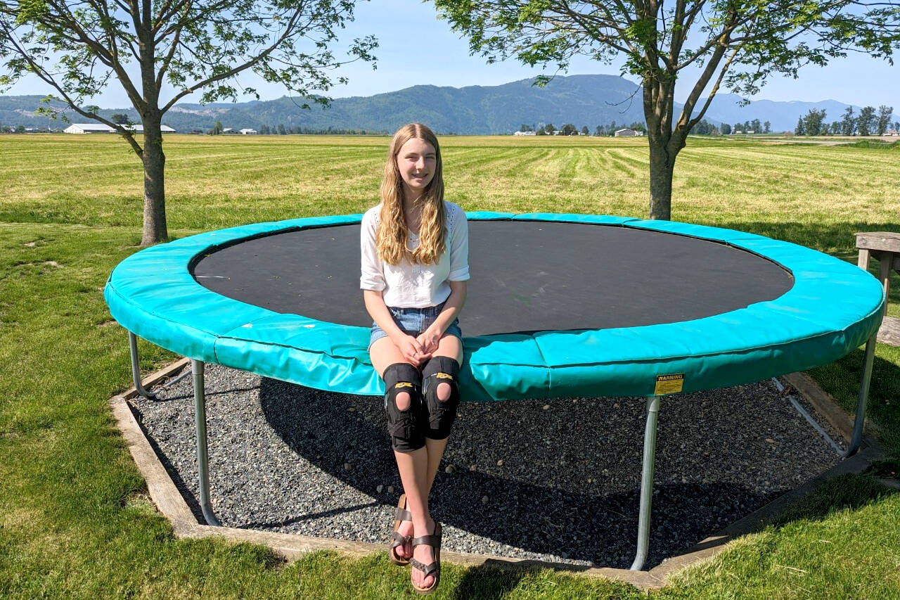 Anna Konrad rests on her family’s trampoline in the Sumas Prairie region of Abbotsford on a recent warm day. She has created a podcast documenting the post-traumatic stress kids like her are experiencing from the flooding in November 2021, and pressuring the government to keep the issue top of mind. (Submitted photo)