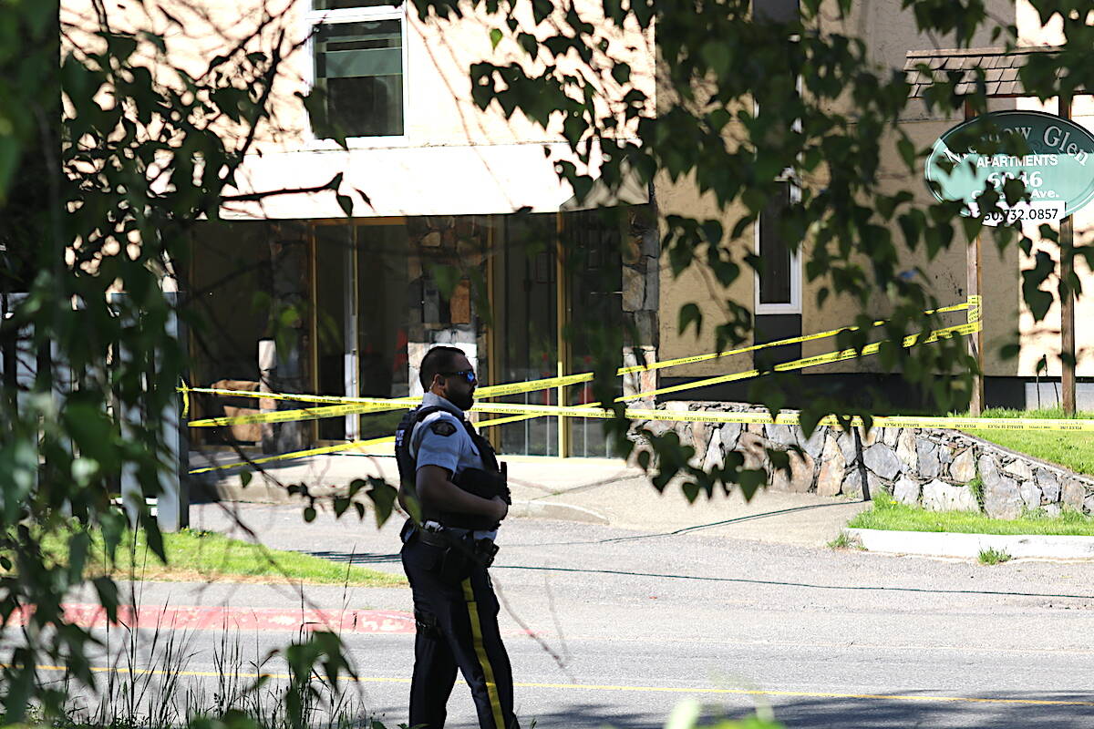 A North Cowichan/Duncan RCMP officer stands watch outside of the Meadow Glen apartment building at 6046 Canada Ave, adjacent to the North Cowichan/Duncan RCMP detachment where a police-involved shooting occurred Friday morning. (Sarah Simpson/Citizen)