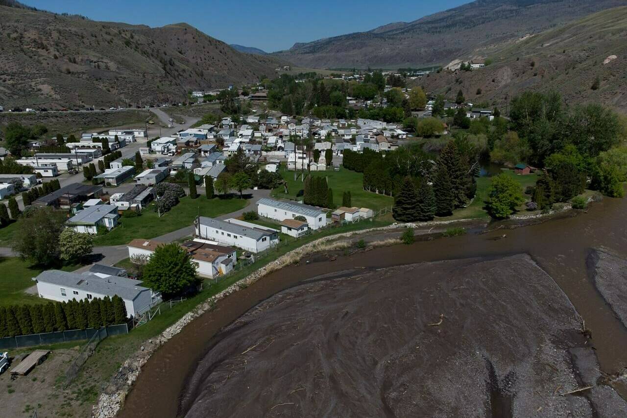 The swollen Bonaparte River flows past an evacuated mobile home community in Cache Creek, B.C., on Sunday, May 14, 2023. A flood warning has been issued for the Skeena region of northwestern British Columbia as unseasonably warm temperatures swell rivers in many areas of the province. THE CANADIAN PRESS/Darryl Dyck