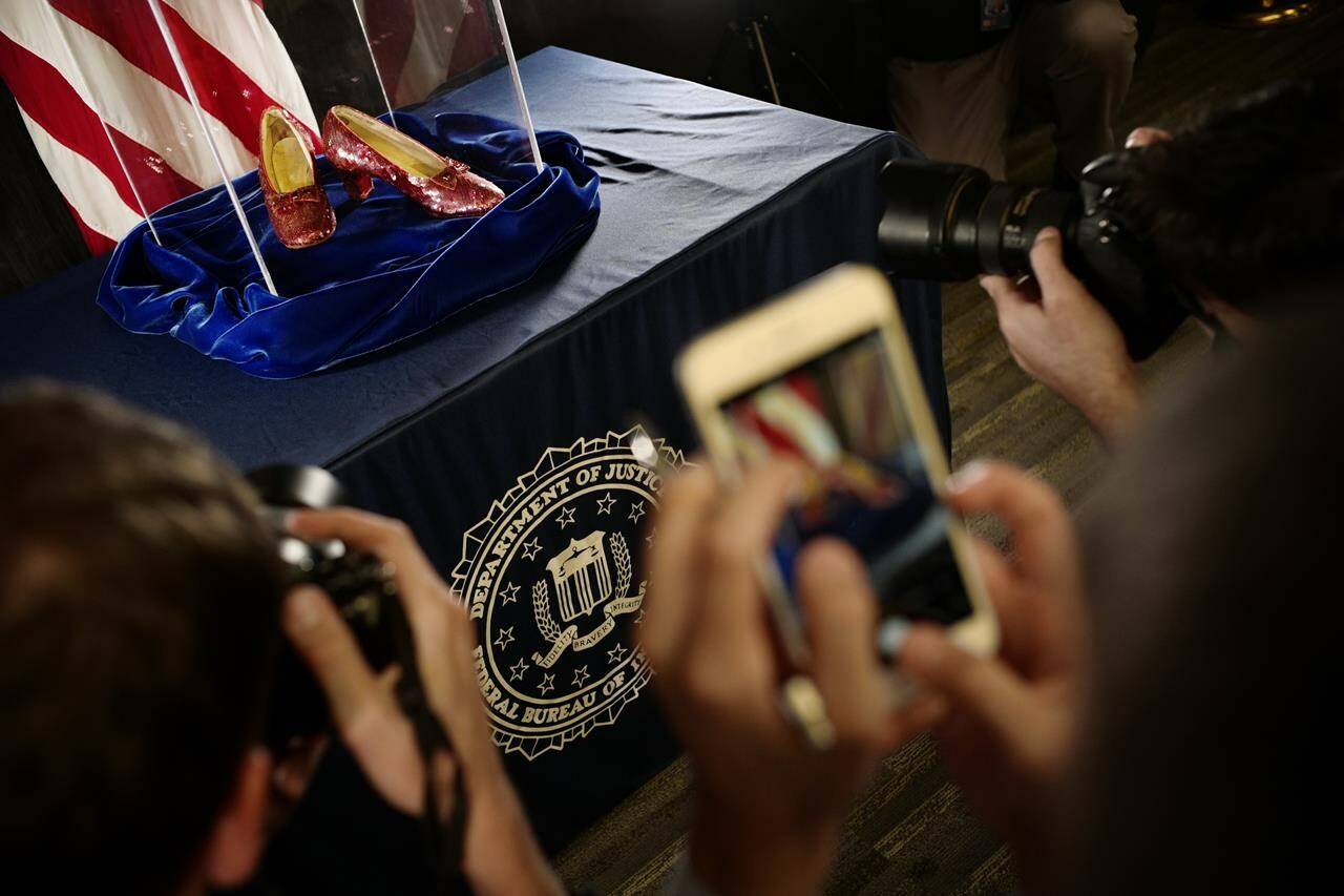 FILE - A pair of ruby slippers once worn by actress Judy Garland in the “The Wizard of Oz” are displayed at a news conference on Sept. 4, 2018, at the FBI office in Brooklyn Center, Minn. Federal prosecutors say a man has been indicted by a grand jury Tuesday, May 16, 2023, on charges of stealing a pair of ruby red slippers worn by Judy Garland in “The Wizard of Oz.” The FBI recovered the slippers in 2018. (Richard Tsong-Taatarii/Star Tribune via AP, File)
