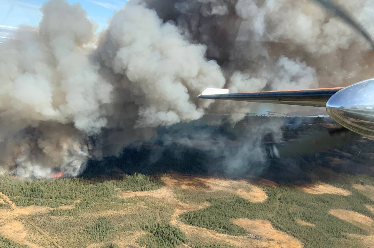 A view of a wildfire over Hay River, Northwest Territories from an air tanker is shown in a May 14, 2023 handout photo. Residents of K’atl’odeeche First Nation and the neighbouring community of Hay River, N.W.T., remain displaced as an out-of-control wildfire continues to burn in the area. THE CANADIAN PRESS/HO-Northwest Territories Environment and Natural Resources **MANDATORY CREDIT**