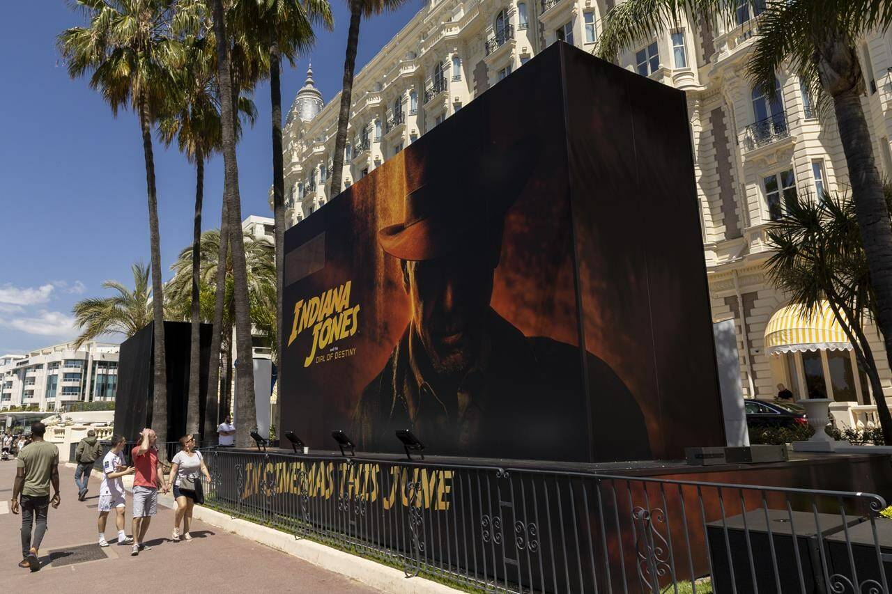 The official poster for ‘Indiana Jones and the Dial of Destiny’ is pictured outside the entrance of the Carlton hotel ahead of the Cannes film festival, in Cannes, southern France, Monday, May 15, 2023. The 76th edition of the film festival runs from May 16 until May 27. (Photo by Joel C Ryan/Invision/AP)