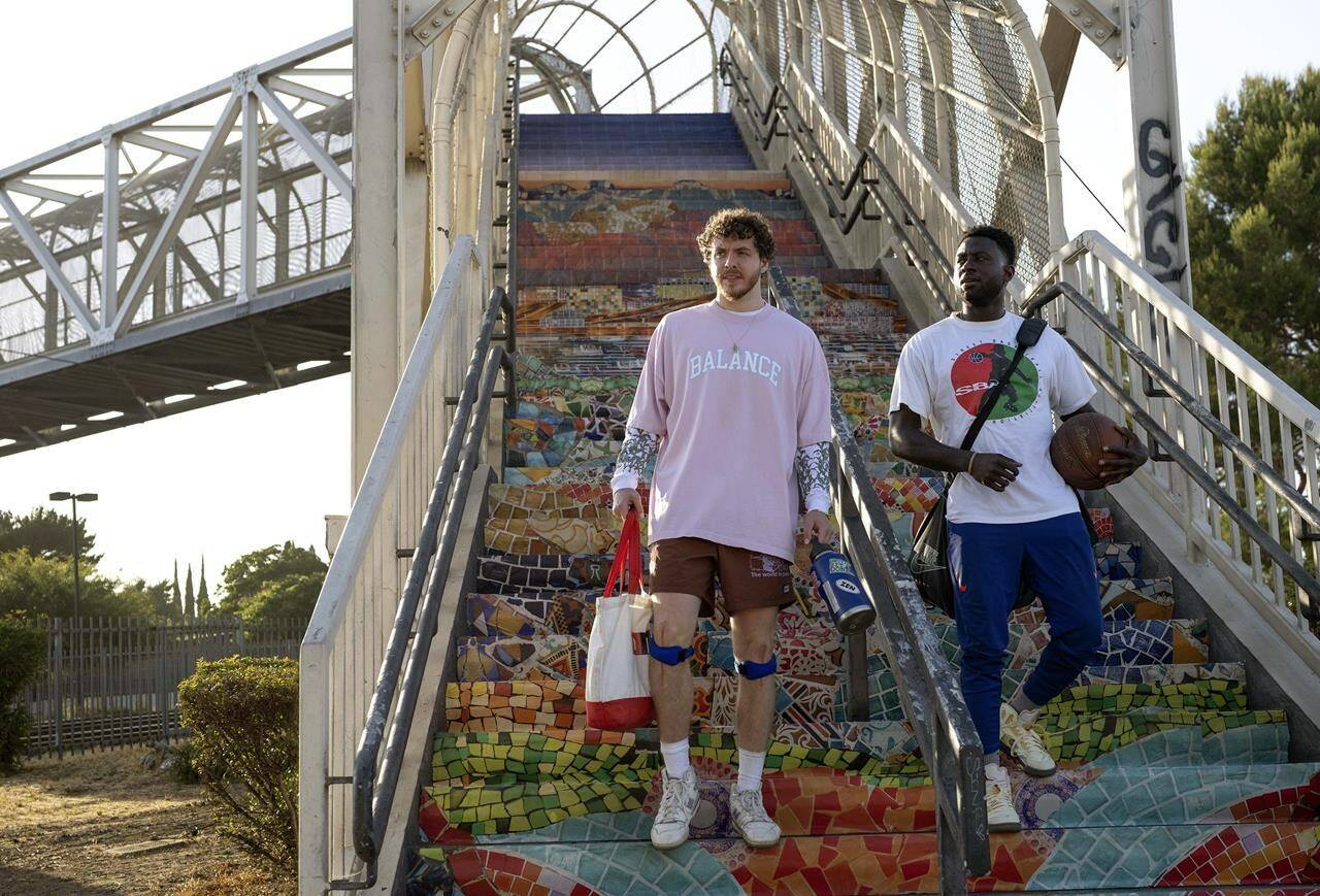 This image released by 20th Century Studios shows Sinqua Walls as Kamal, right, and Jack Harlow as Jeremy in a scene from “White Men Can’t Jump.” (Parrish Lewis/20th Century Studios via AP)