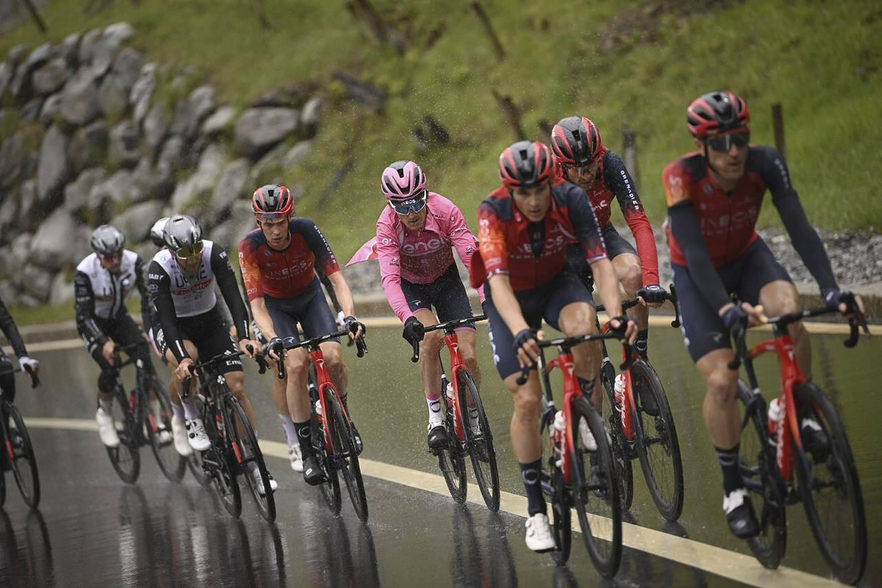 Britain’s Geraint Thomas of Ineos Grenadiers, center in pink, competes during the 14th stage of the Giro D’Italia, tour of Italy cycling race, from Sierre to Cassano Magnago, Saturday May 20, 2023. (Fabio Ferrari/LaPresse via AP)