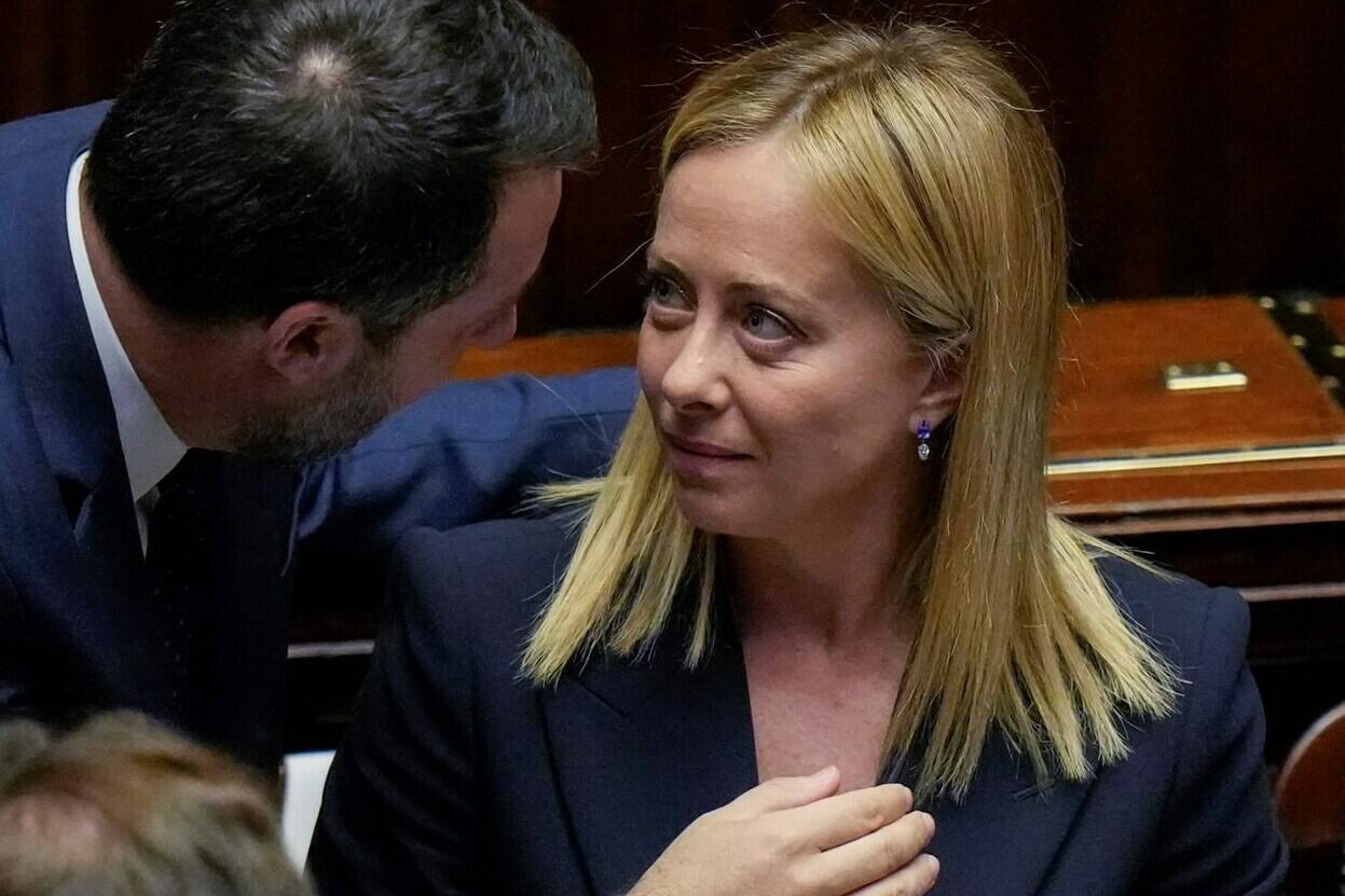 Italian Premier Giorgia Meloni, right, talks to Infrastructures Minister Matteo Salvini after addressing the lower Chamber ahead of a confidence vote for her Cabinet, Sunday, Oct. 23, 2022. Giorgia Meloni, whose party with neo-fascist roots finished first in recent elections, is Italy’s first far-right premier since the end of World War II. She is also the first woman to serve as Italian premier. (AP Photo/Alessandra Tarantino)