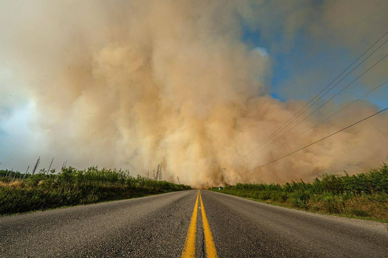 Smoke from a wildfire is shown crossing a road in British Columbia in this undated handout image provided by the BC Wildfire Service. THE CANADIAN PRESS/HO-BC Wildfire Service **MANDATORY CREDIT**