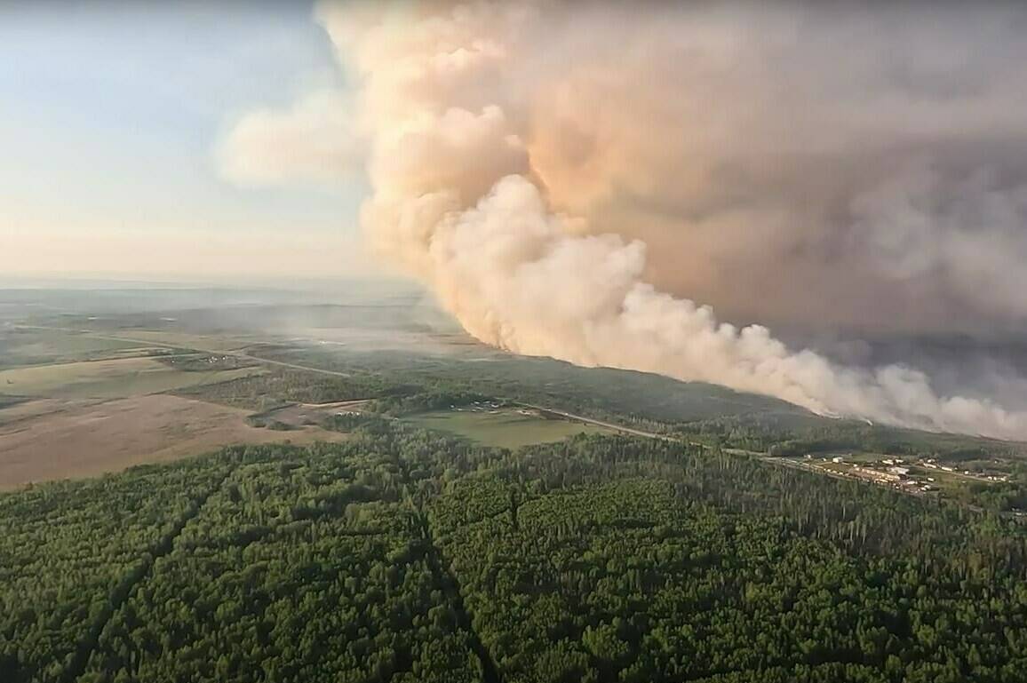 All evacuation orders related to wildfires in northeastern British Columbia have now been lifted or downgraded to evacuation alerts as heavy rain eases the fire danger. The Peace River Regional District has cancelled orders issued last week affecting properties threatened by the Stoddart Creek fire northeast of Fort St. John. Smoke is shown as the Stoddart Creek wildfire burns in British Columbia in this May 14, 2023, handout image taken from video. THE CANADIAN PRESS/HO-BC Wildfire Service **MANDATORY CREDIT**