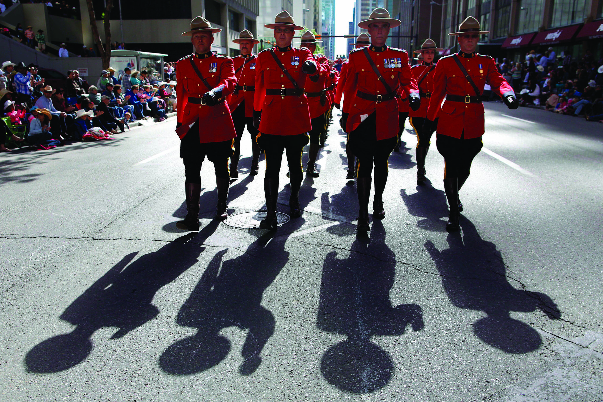 Members of the RCMP march during the Calgary Stampede parade in Calgary, Friday, July 5, 2013. THE CANADIAN PRESS/Jeff McIntosh