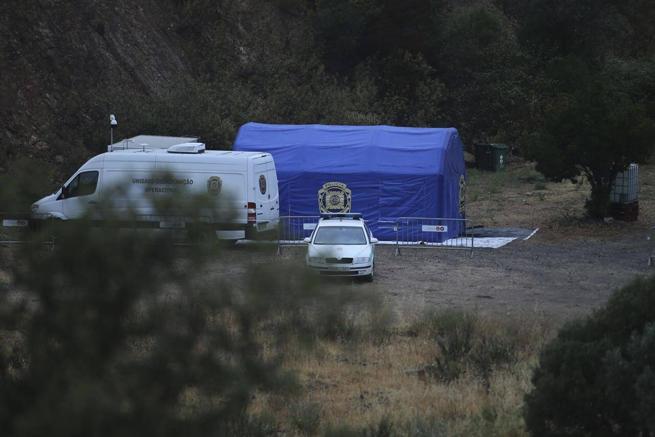 A police tent and vehicles are seen near the Arade dam, about 50 kilometers (31 miles) from Praia da Luz in Portugal, Tuesday May 23, 2023. Portuguese police said they will resume searching for Madeleine McCann, the British toddler who disappeared in the country's Algarve region in 2007, in the next few days. Earlier on Monday, police were seen erecting tents and cordons in an area where the 3-year-old was last seen alive. (AP Photo/Joao Matos)