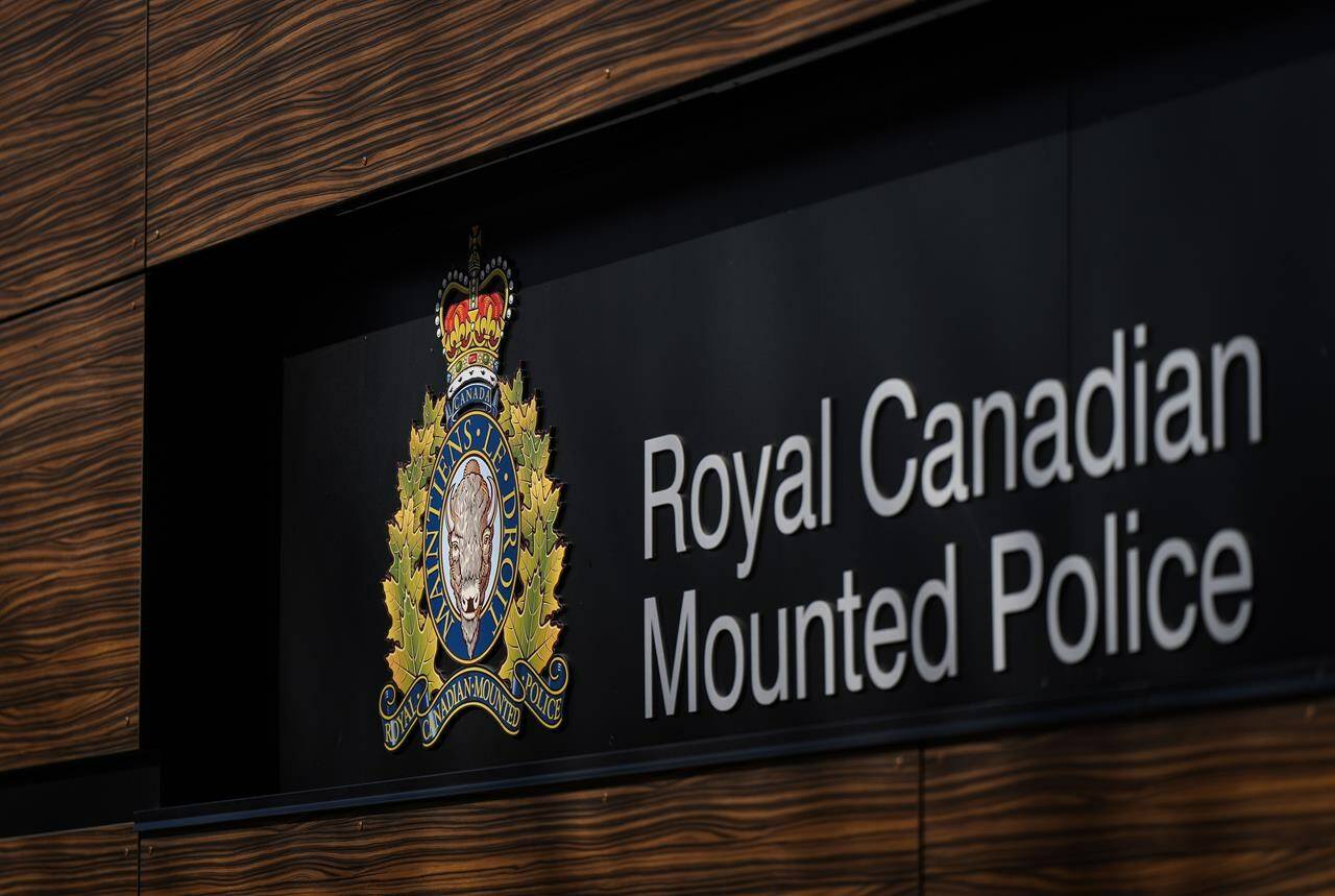 The RCMP logo is seen outside the force’s ‘E’ division headquarters in Surrey, B.C., on Thursday, March 16, 2023. A school bus was tipped over on the Sunshine Coast Wednesday morning (May 24, 2023) and one driver and one student were on-board. THE CANADIAN PRESS/Darryl Dyck