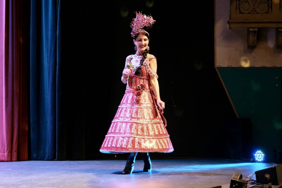 Madame Cola, designed by Shirley McLim. Can-can dress crafted from pop tabs and crochet thread for the bodice, and coke tins, crochet thread and stiff wire for the skirt. Hat and rose accessories made from coke tins. Model: Tiffany McLim. Photo: Bill Metcalfe