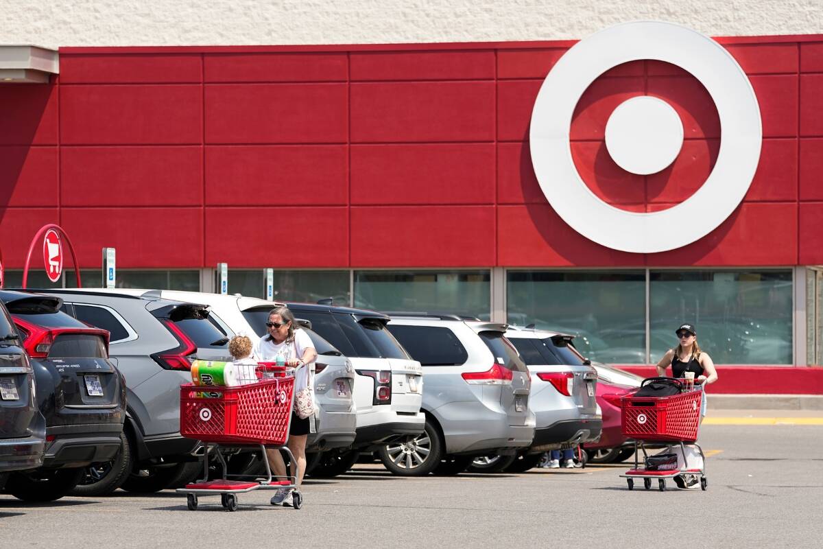 Customers make their way through the parking lot of a Target store Wednesday, May 24, 2023, in Nashville, Tenn. Target is removing certain items from its stores and making other changes to its LGBTQ+ merchandise nationwide ahead of Pride month after an intense backlash from some customers including violent confrontations with its workers. (AP Photo/George Walker IV