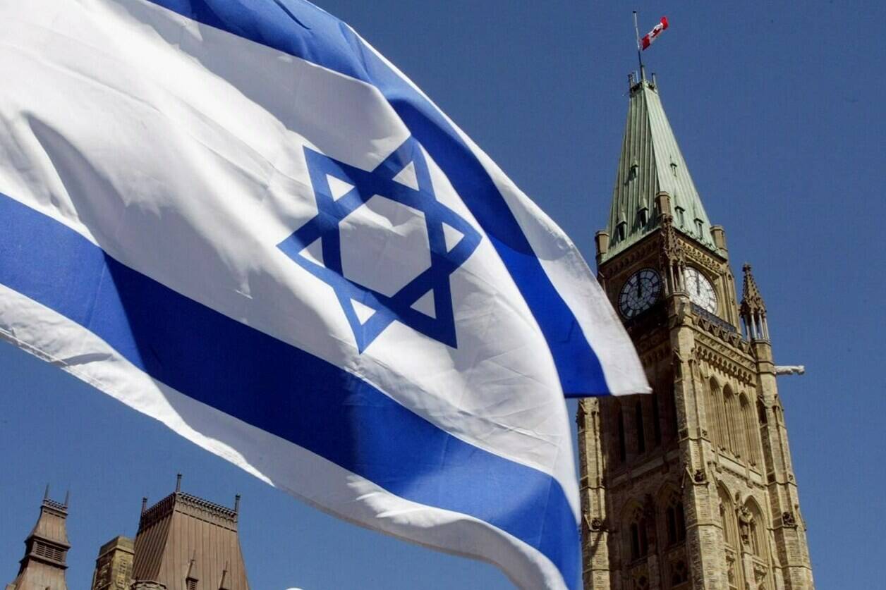 The Israeli flag flies with the Peace Tower in the background on Parliament Hill in Ottawa on April 21, 2002. THE CANADIAN PRESS/Jonathan Hayward
