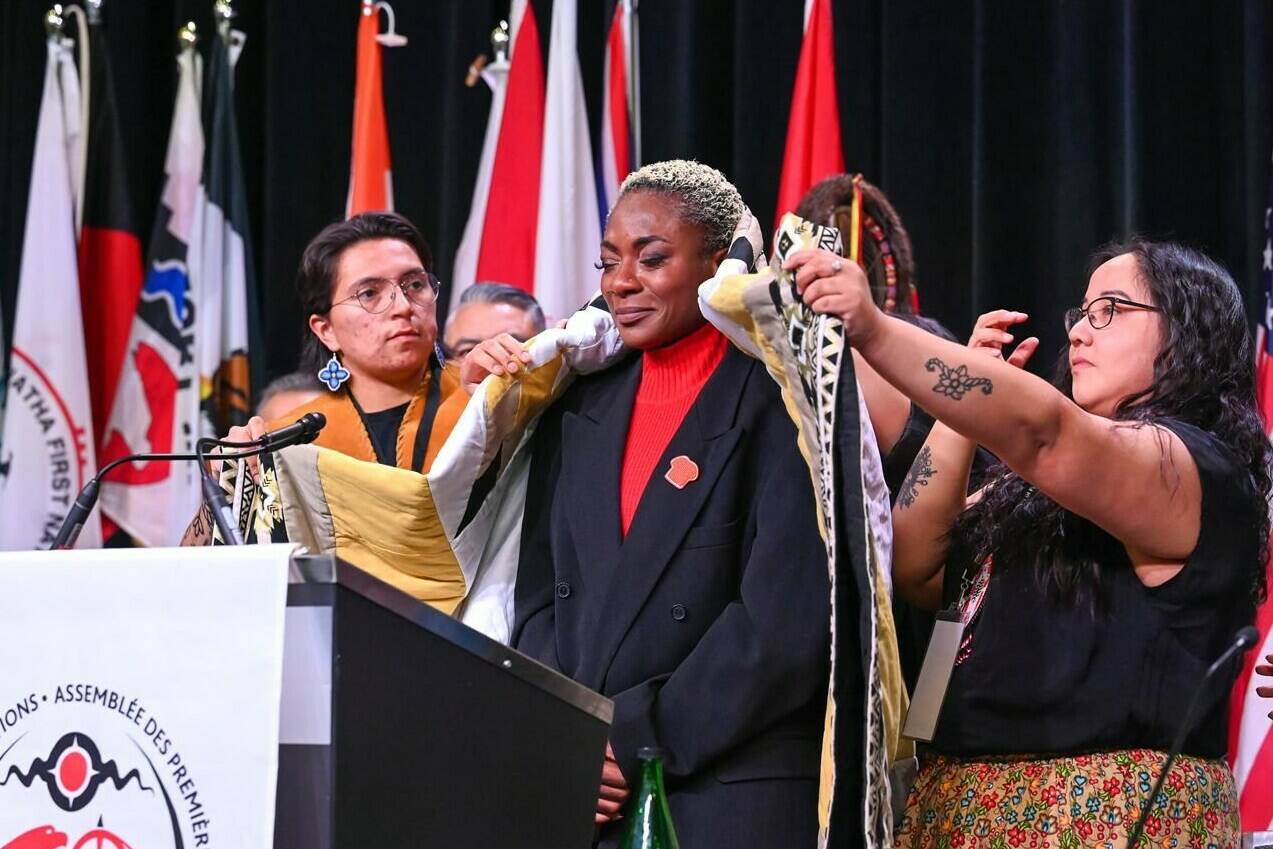 Canadian R&B singer Jully Black (centre) was honoured at an AFN Special Chiefs Assembly in Ottawa, Monday, April 3, 2023 for making an appreciated tweak to the Canadian national anthem at the NBA All-Star Game in Salt Lake City, Utah in February. Black was presented with an eagle feather and wrapped with a blanket during a Blanketing Ceremony by AFN Knowledge Keepers and National Chief RoseAnne Archibald. THE CANADIAN PRESS/AFN-Fred Cattroll **MANDATORY CREDIT **