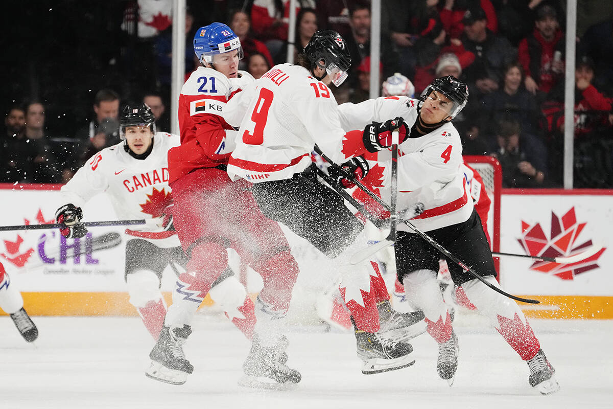Canada’s Adam Fantilli, centre, and Tyson Hinds, right, collide with Czechia’s Jaroslav Chmelar during first period IIHF World Junior Hockey Championship hockey action in Halifax, Monday, Dec. 26, 2022. THE CANADIAN PRESS/Darren Calabrese