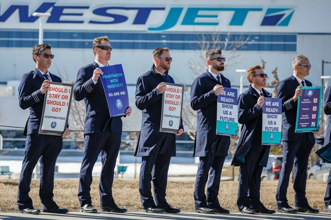 WestJet pilots are poised to get a 24 per cent pay bump over four years under an agreement-in-principle between the company and the union. Members of the Air Line Pilots Association demonstrate amid contract negotiations outside the WestJet headquarters in Calgary, Alta., Friday, March 31, 2023.THE CANADIAN PRESS/Jeff McIntosh