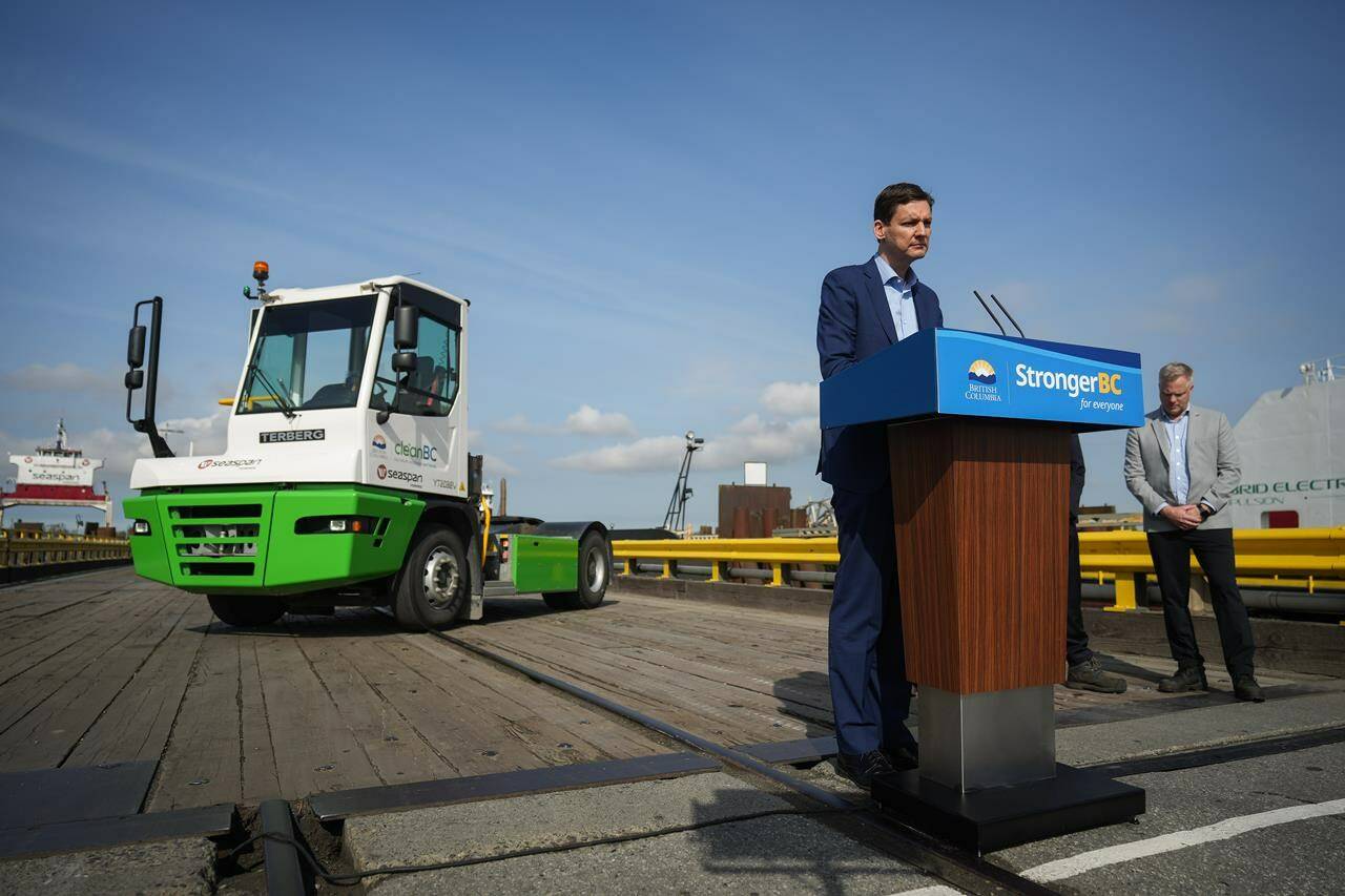 British Columbia Premier David Eby stands behind a height-adjustable podium during an announcement at the Seaspan Ferries Tilbury Terminal in Delta, B.C., on Thursday, April 27, 2023. THE CANADIAN PRESS/Darryl Dyck