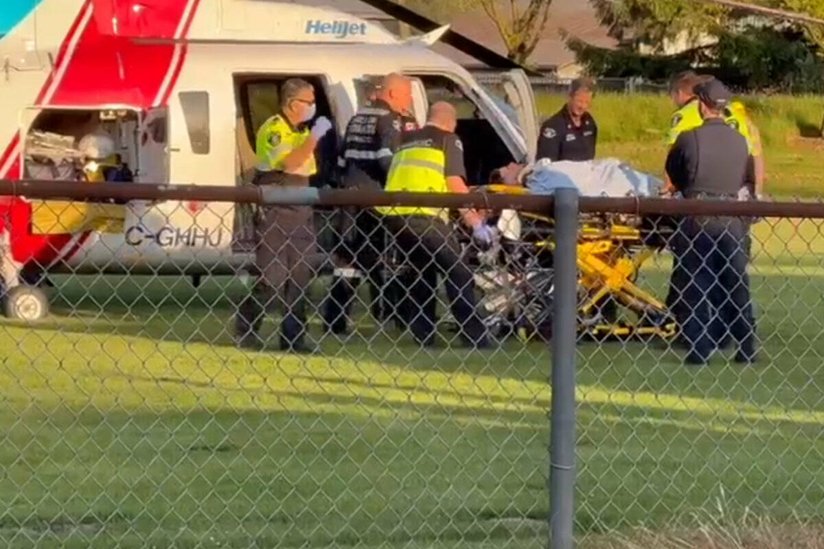 A motorcyclist is loaded into a B.C. Air Ambulance after 8 p.m. on May 29, 2023 in Rosedale Park in Chilliwack after a crash that happened shortly after 7 p.m. (Submitted photo)