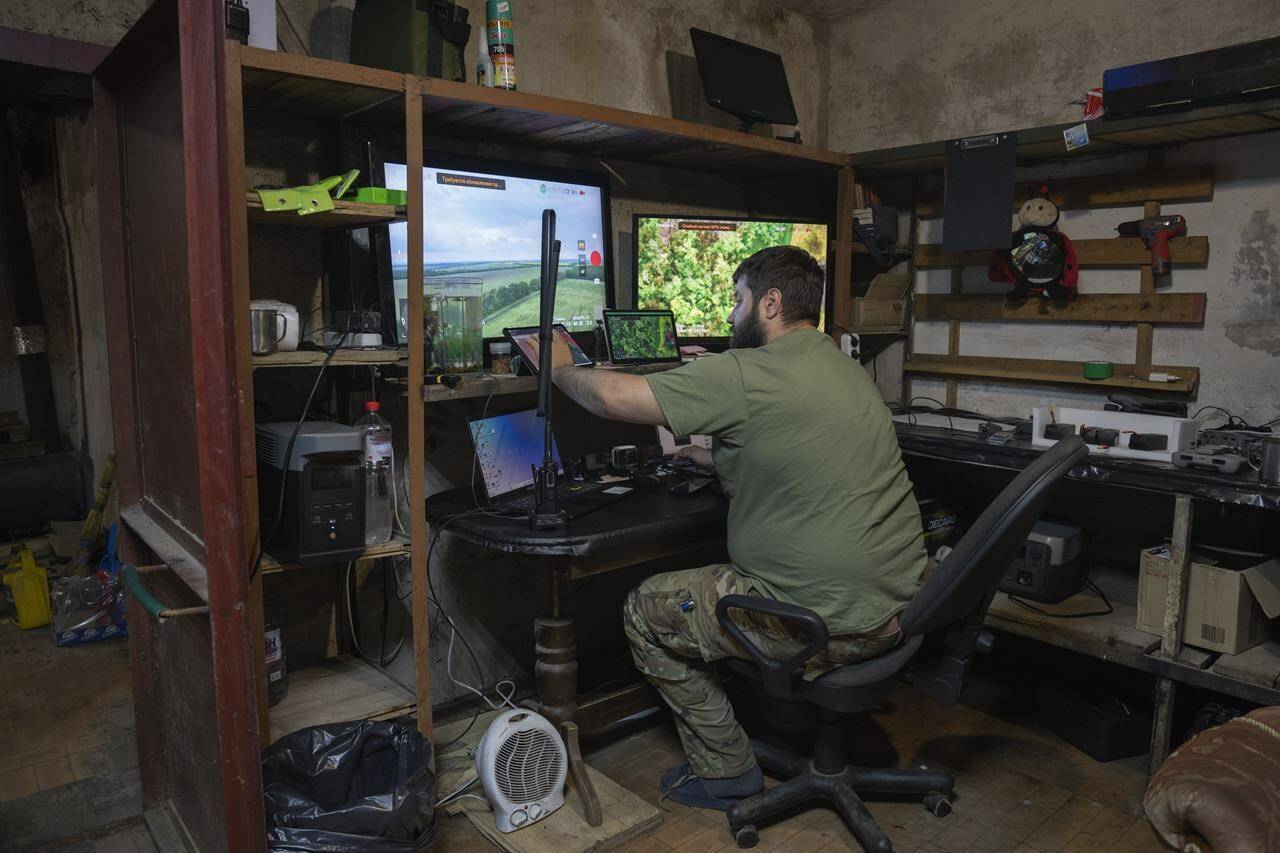 A Ukrainian officer works in his battalion headquarters on the frontline near Bakhmut, Donetsk region, Ukraine, Monday, May 29, 2023. (AP Photo/Efrem Lukatsky)