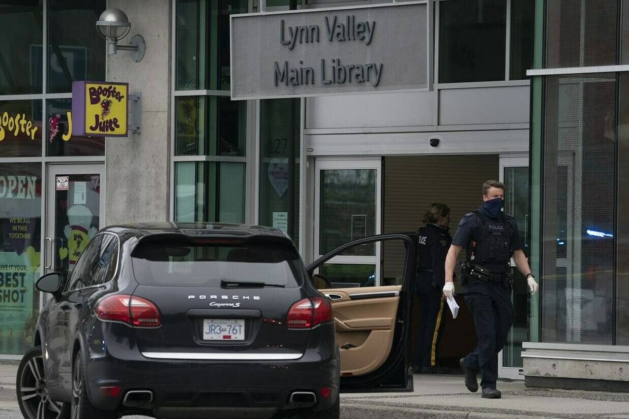 Members of the RCMP are seen outside of the Lynn Valley Library, in North Vancouver, B.C., Saturday, March 27, 2021. The man who stabbed numerous people in and around the library two years ago has pleaded guilty to murder and other charges. THE CANADIAN PRESS/Jonathan Hayward