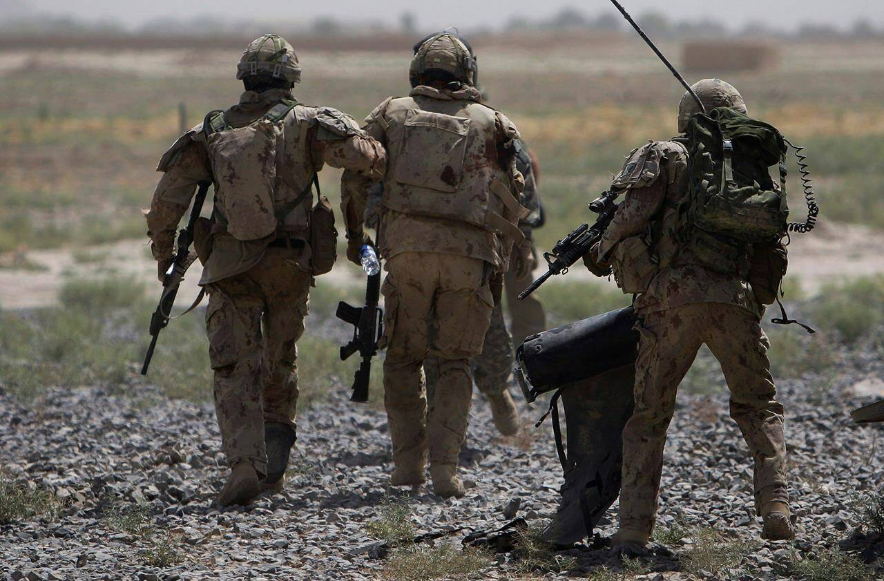 Canadian soldiers help a comrade get on a helicopter after he was injured in an IED blast during a patrol outside Salavat, in the Panjwayi district, southwest of Kandahar, Afghanistan, Monday, June 7, 2010. Two Canadians who served the military in Afghanistan are suing the federal government over allegations of discrimination when it comes to rescuing their family members from the Taliban. THE CANADIAN PRESS/AP/Anja Niedringhaus