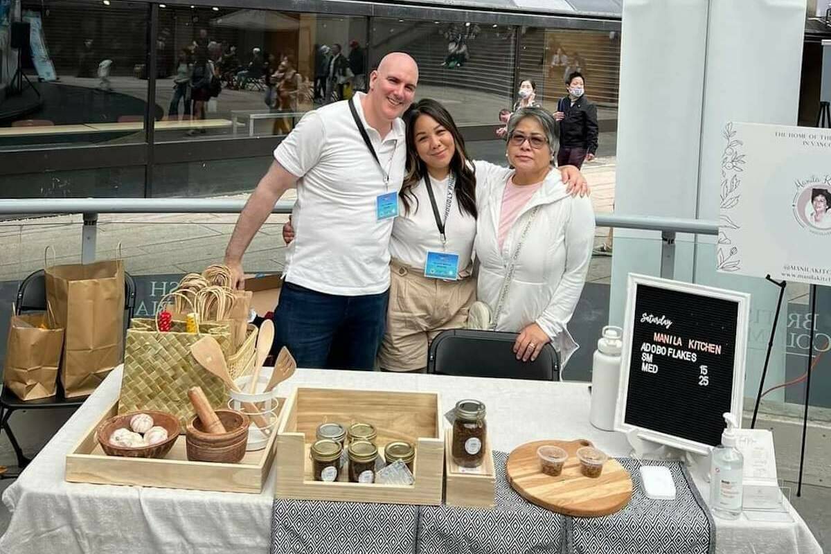 Natasha Acuba-Bailey (centre), her husband Mark (left), and mother Telly (right), selling adobo flakes at Robson Square (Contributed Natasha Acuba-Bailey).