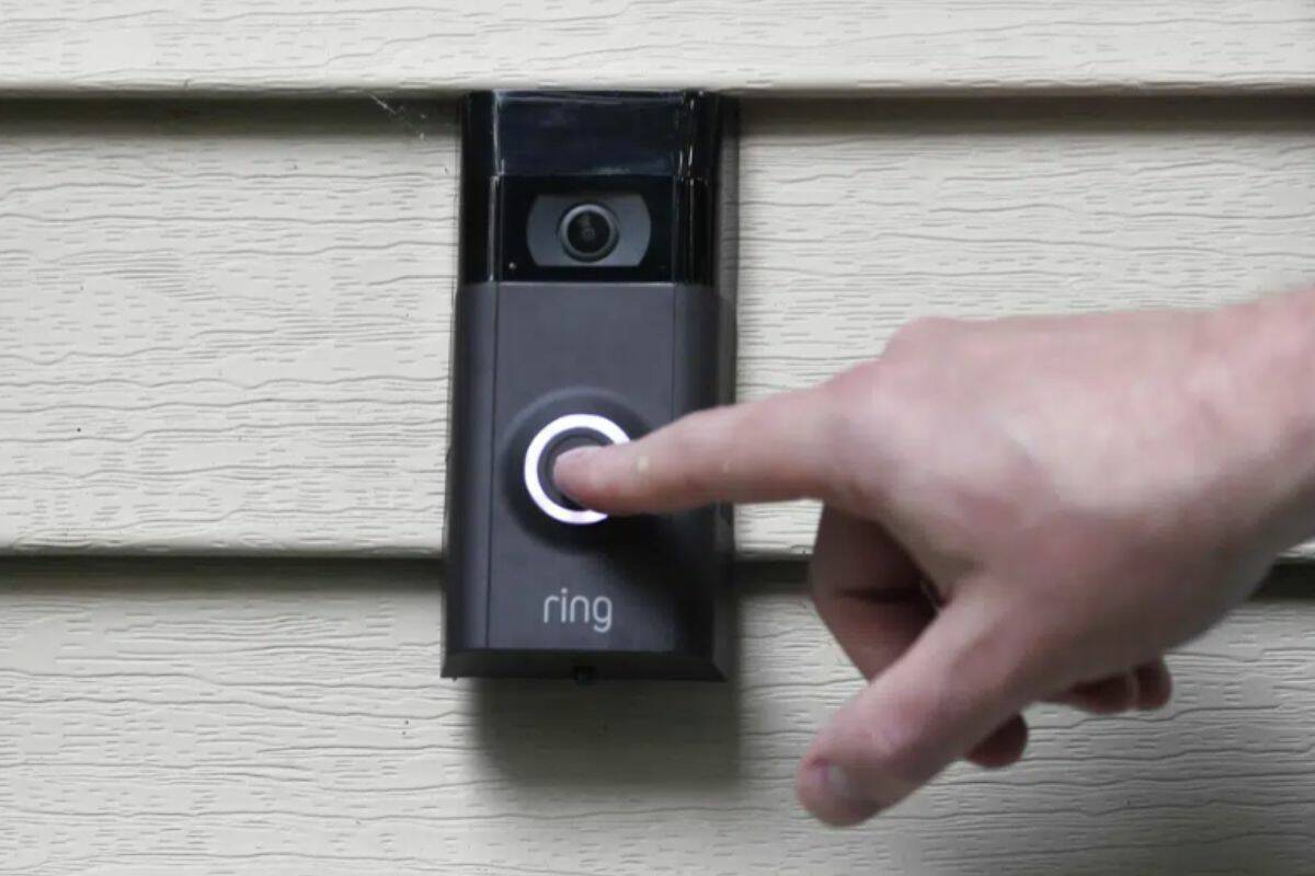 FILE - Ernie Field pushes the doorbell on his Ring doorbell camera, July 16, 2019, at his home in Wolcott, Conn. In a vote Wednesday, May 31, 2023, the Federal Trade Commission is ordering Amazon to pay more than $30 million in fines over privacy violations involving its voice assistant Alexa and its doorbell camera Ring. (AP Photo/Jessica Hill, File)