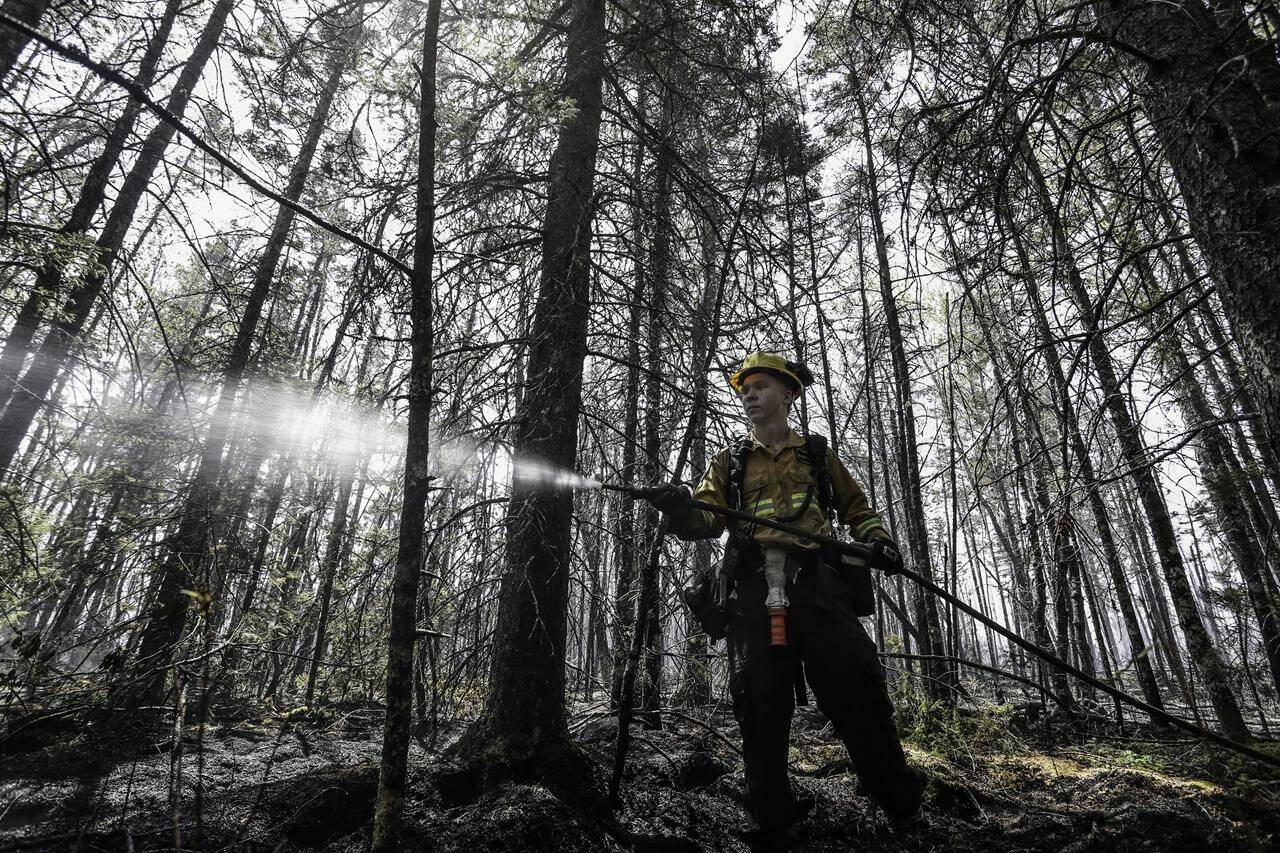 Department of Natural Resources and Renewables firefighter Kalen MacMullin of Sydney, N.S., works on a fire in Shelburne County, N.S., in a Thursday, June 1, 2023 handout photo. Almost 700 international firefighters from South Africa, Australia, New Zealand and the United States are set to arrive in Canada over the next two weeks to help with an unusually severe start to wildfire season across the country. THE CANADIAN PRESS/HO-Communications Nova Scotia **MANDATORY CREDIT**