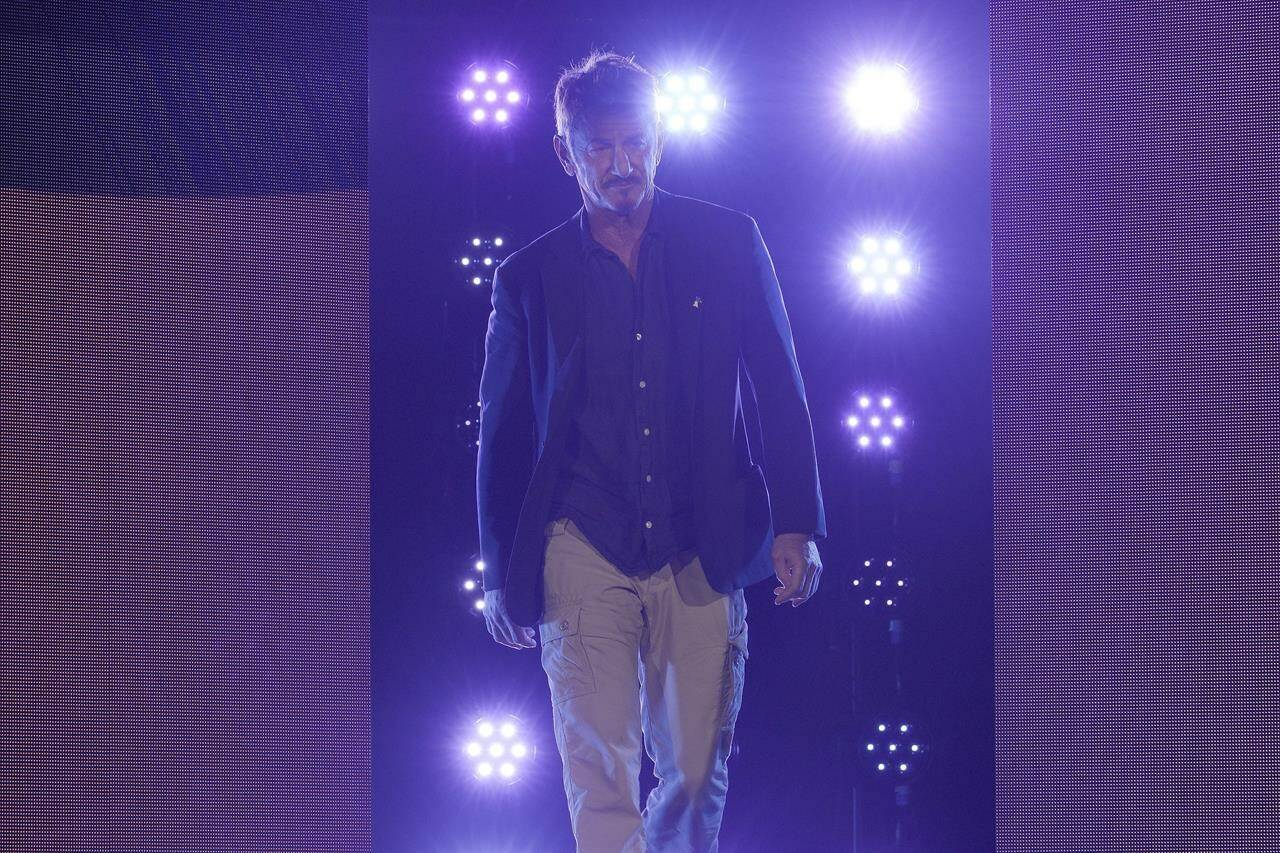 Sean Penn walks on stage prior to introducing a live video link with Ukrainian President Volodymyr Zelenskyy during the opening ceremony at the International Film Festival Berlin ‘Berlinale’, in Berlin, Germany, Thursday, Feb. 16, 2023. THE CANADIAN PRESS/AP-Markus Schreiber