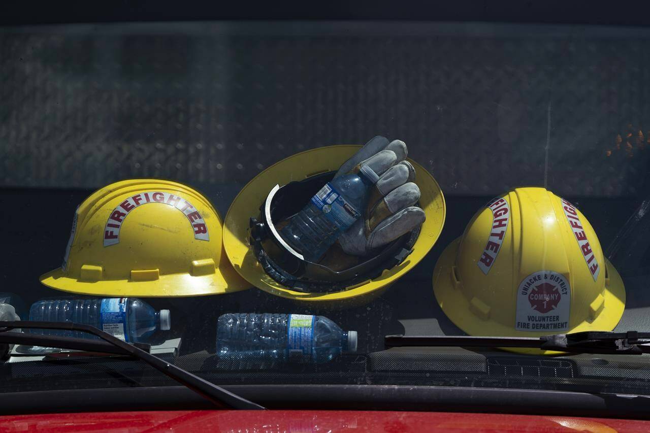 Firefighters’ helmets and water bottles rest against the windshield of a truck at a command centre within the evacuated zone of the wildfire burning in Tantallon, N.S., outside of Halifax on Wednesday, May 31, 2023. Scattered showers are moving across parts of Nova Scotia this morning, providing some relief to a province still struggling with its worst wildfire season on record. THE CANADIAN PRESS/Darren Calabrese