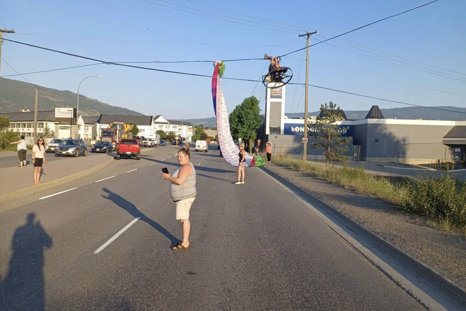 The pilot of a power parachute made an unexpected landing in Vernon, getting tangled in telephone wires above Highway 97 near London Drugs Friday, June 2, 2023. The highway is closed southbound while crews attend to the incident. (Submitted photo)