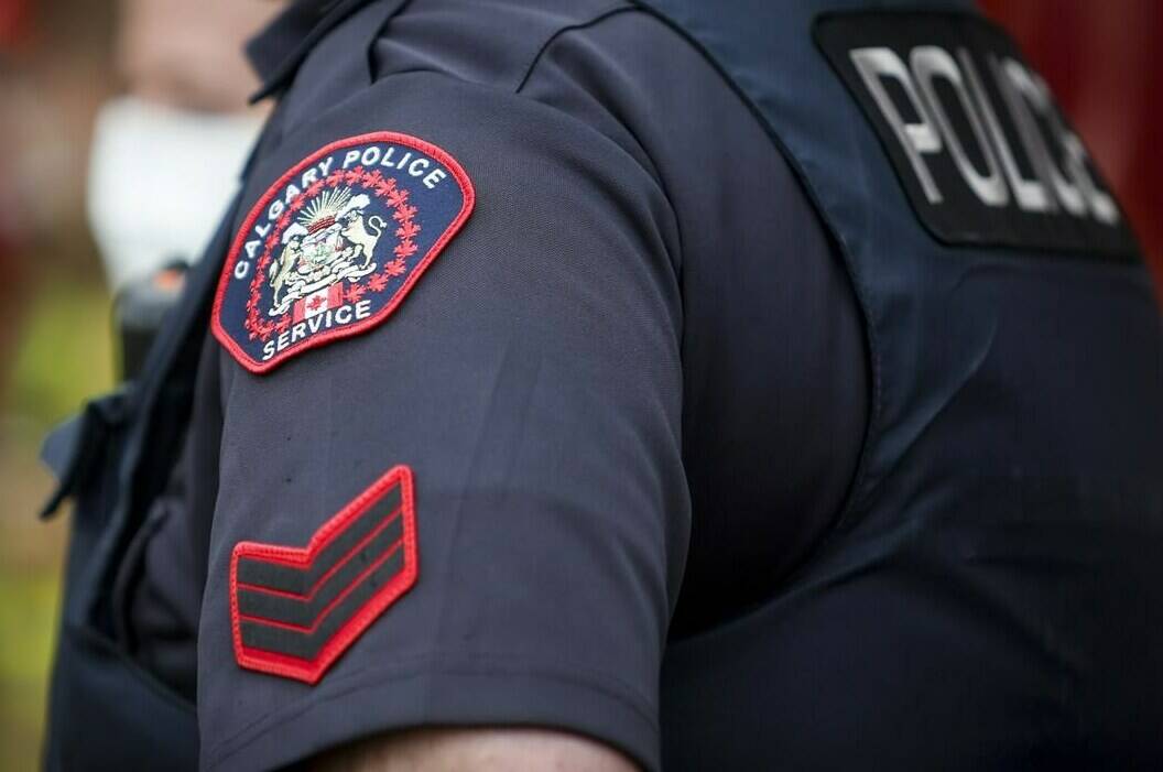 Calgary police say a father and his son have been arrested and charged after multiple teenage girls were sexually exploited, assaulted and extorted for several months. A Calgary Police Service officer is seen in Calgary on April 14, 2020. THE CANADIAN PRESS/Jeff McIntosh