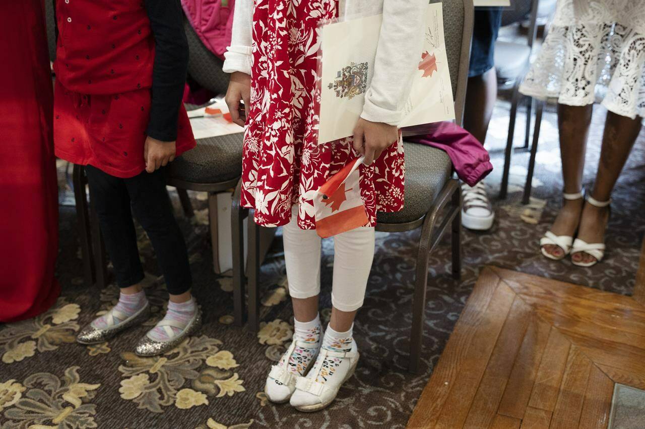 Children stand to sing O Canada after being sworn-in as Canadian citizens at the Halifax Citadel in Halifax on Wednesday, May 24, 2023. THE CANADIAN PRESS/Darren Calabrese