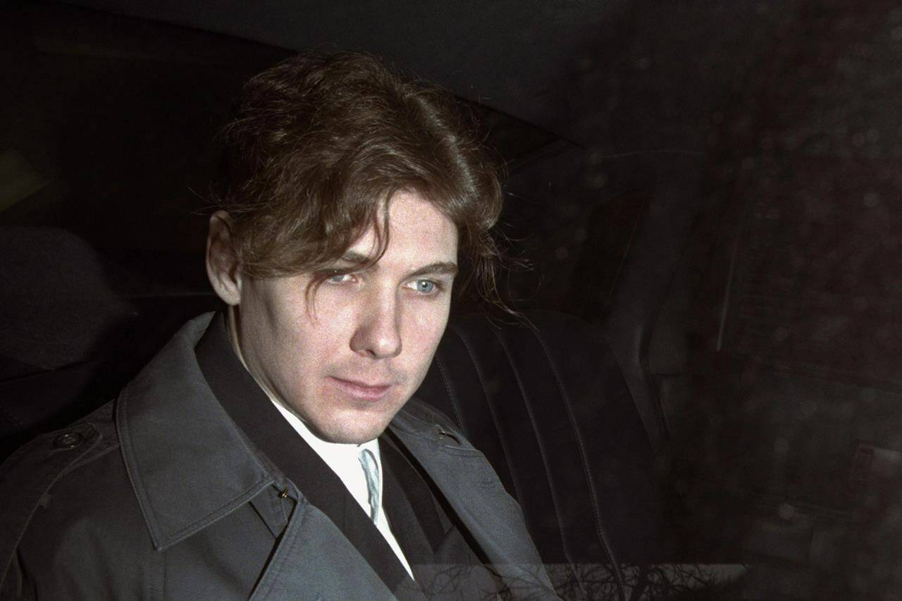 Paul Bernardo sits in the back of a police cruiser as he leaves a hearing in St. Catharines, Ont., April 5, 1994. The lawyer for the families of Paul Bernardo’s victims says the killer and serial rapist should be returned to his maximum-security prison and transparency be provided around what led to his transfer to a medium-security facility in the first place.THE CANADIAN PRESS/Frank Gunn